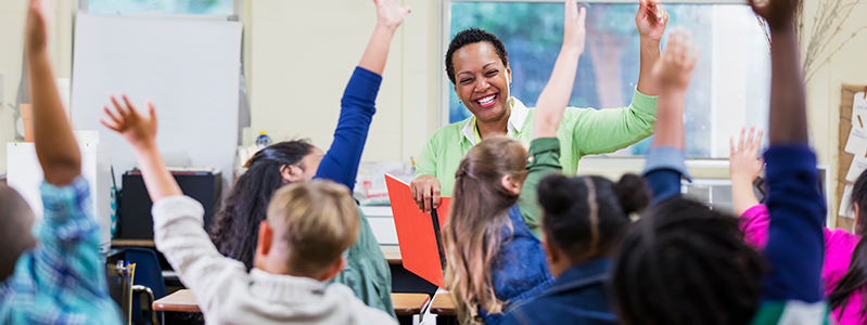 African-American Teacher with Kids raising hands