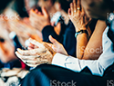 Hands clapping at a conference